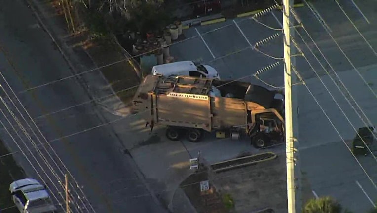 A sanitation worker was struck by a vehicle while helping a garbage truck back up Tuesday morning.