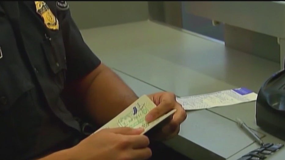File: A persons flipping through a passport. 