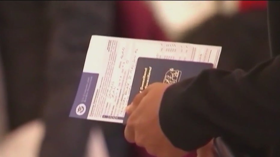 File: A traveler with a passport in hand. 