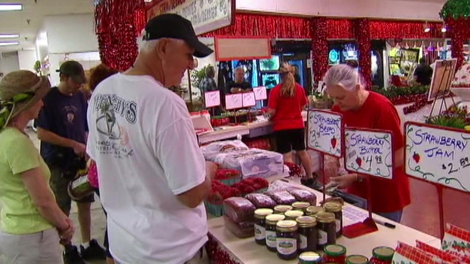 Man buying strawberries at the Strawberry Festival. 