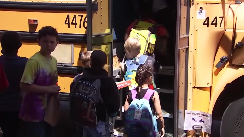 File image of students getting on a school bus. 
