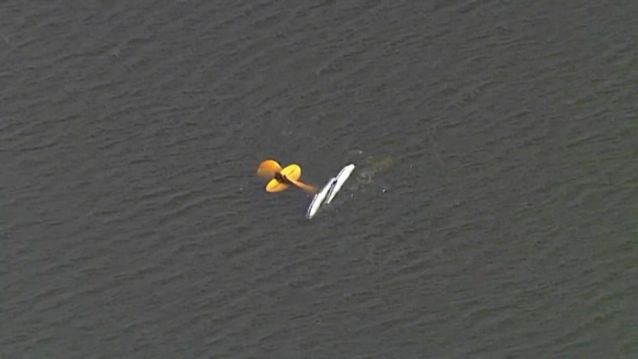 Aerial view of partially submerged plane after crash. 