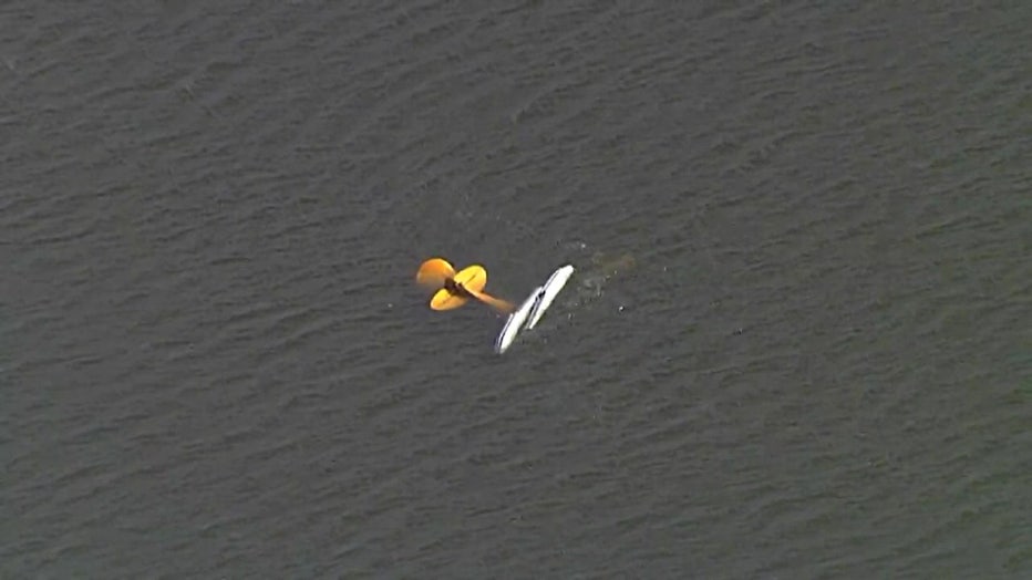 Aerial view of partially submerged plane after crash.