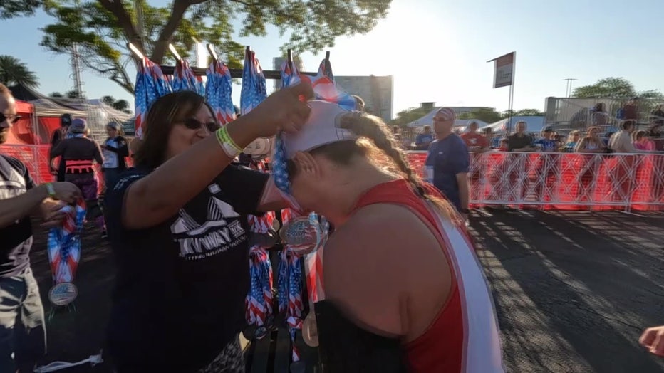 A runner gets a medal for completing the Skyway 10K. 