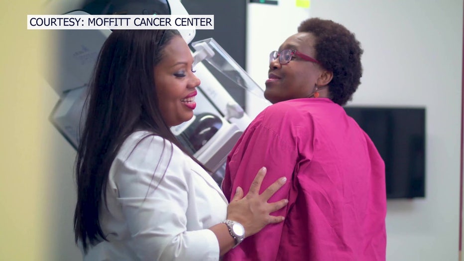 Healthcare professional along with a woman getting a mammogram. 