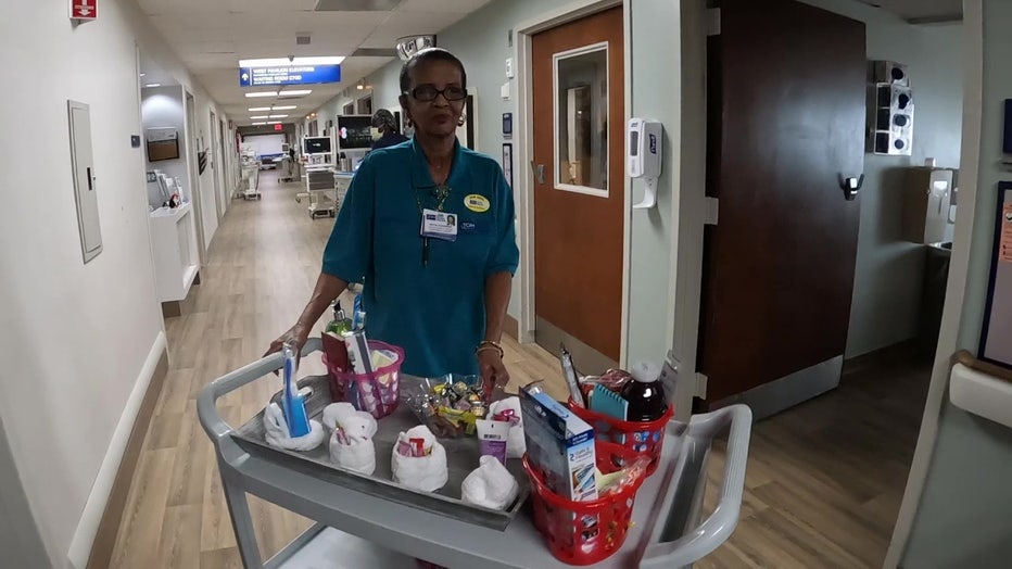 Miss Bettie wheels a cart full of goodies through the halls of TGH.