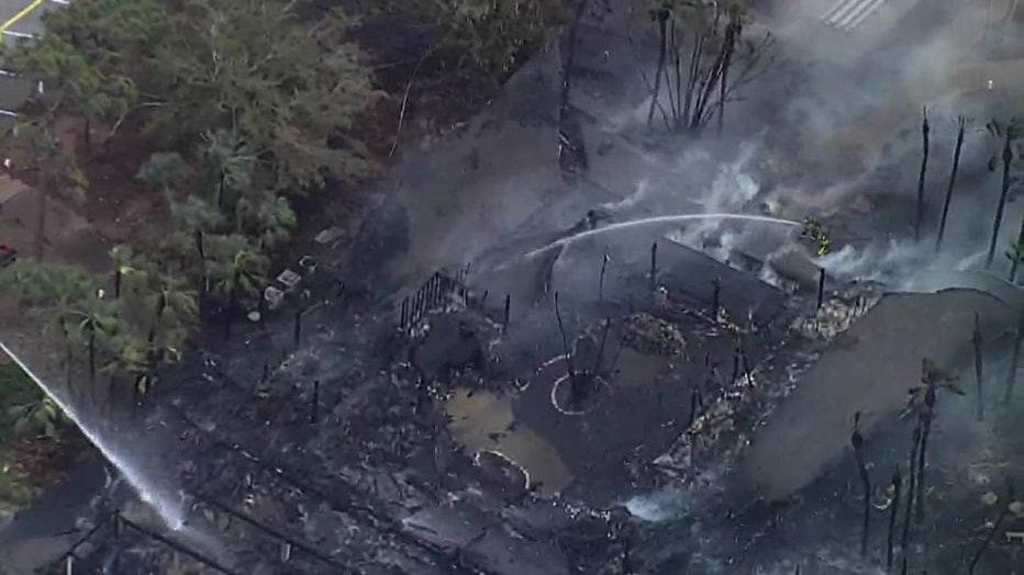 Aerial view of firefighters trying to put out fire at Venice mobile home community clubhouse.