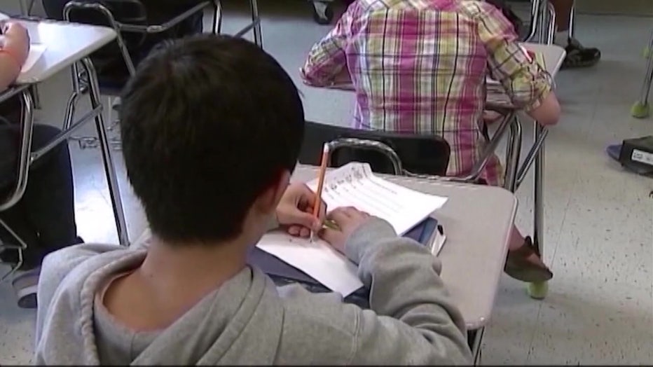 File: Student writing in notebook.