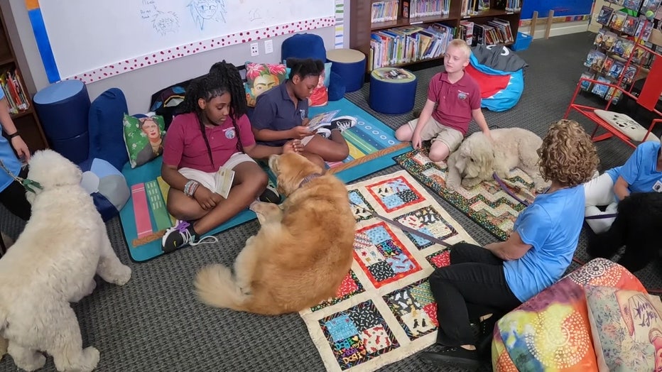 Children read to dogs at Pepin Academies Riverview School. 