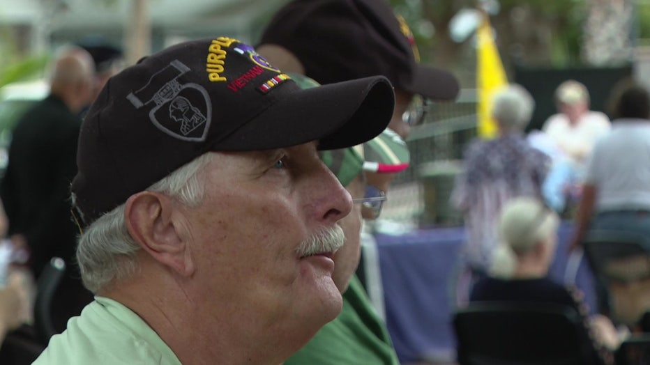 A man wearing a Vietnam veteran hat attends service honoring Vietnam vets. 