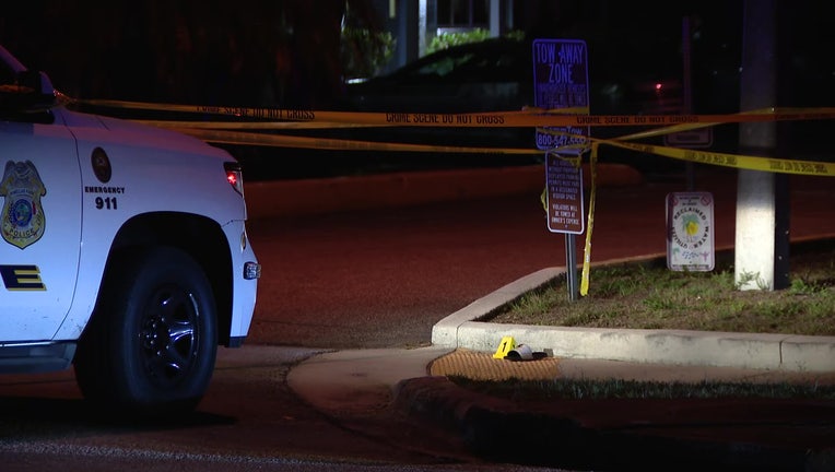 Police vehicle and crime scene tape outside of an apartment where two people were shot, one fatally, early Tuesday morning. 