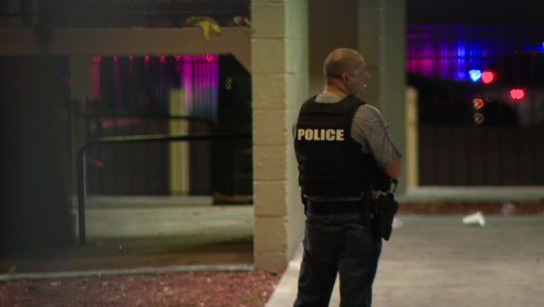 A police officer stands outside the Columbus Court Apartments where a teen was shot Tuesday night.
