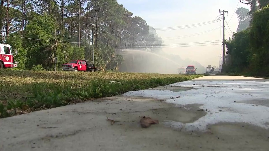 Crews putting out a brush fire.