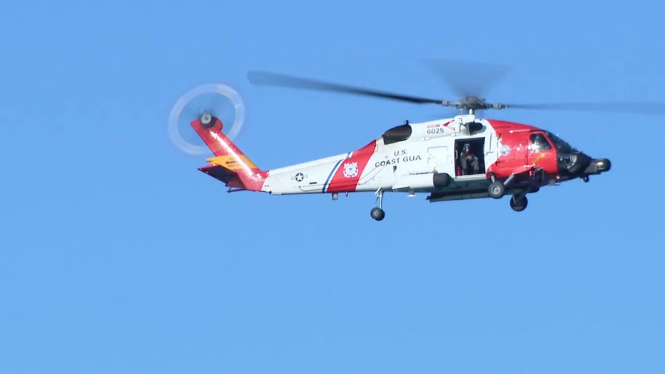 A helicopter searches the water off the Venice pier after four people were killed in a plane crash Wednesday night.