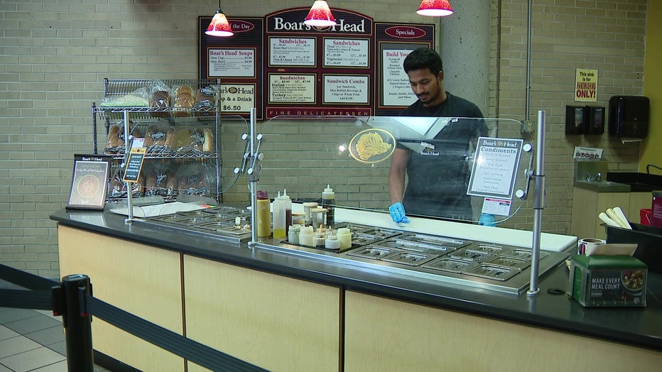 A man behind a deli counter. 