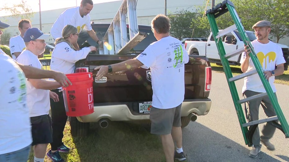 Paint Your Heart Out load up gear to paint homes for low-income residents.