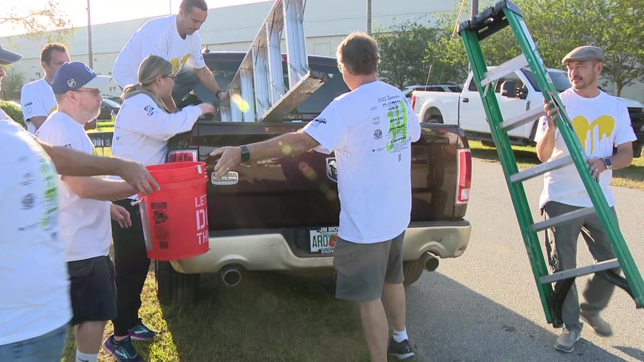 Paint Your Heart Out load up gear to paint homes for low-income residents. 