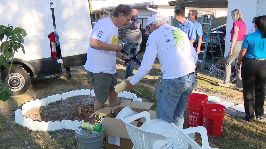 Paint Your Heart Out volunteers prepare brushes for annual painting event. 