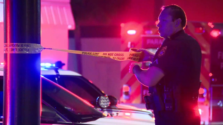 Tampa police officer puts crime scene tape out in front of nightclub where a woman was shot early Monday morning.
