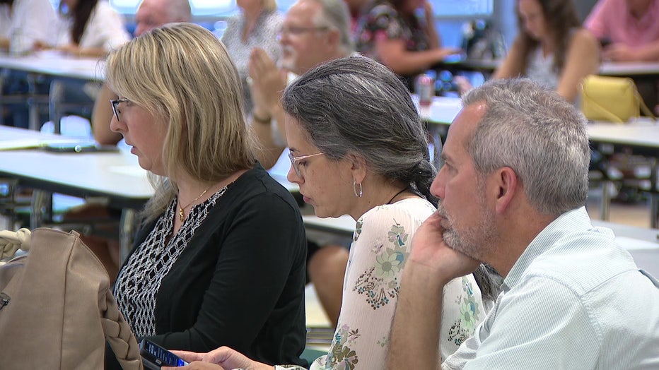 Residents attend a town hall meeting to discuss a new superintendent.