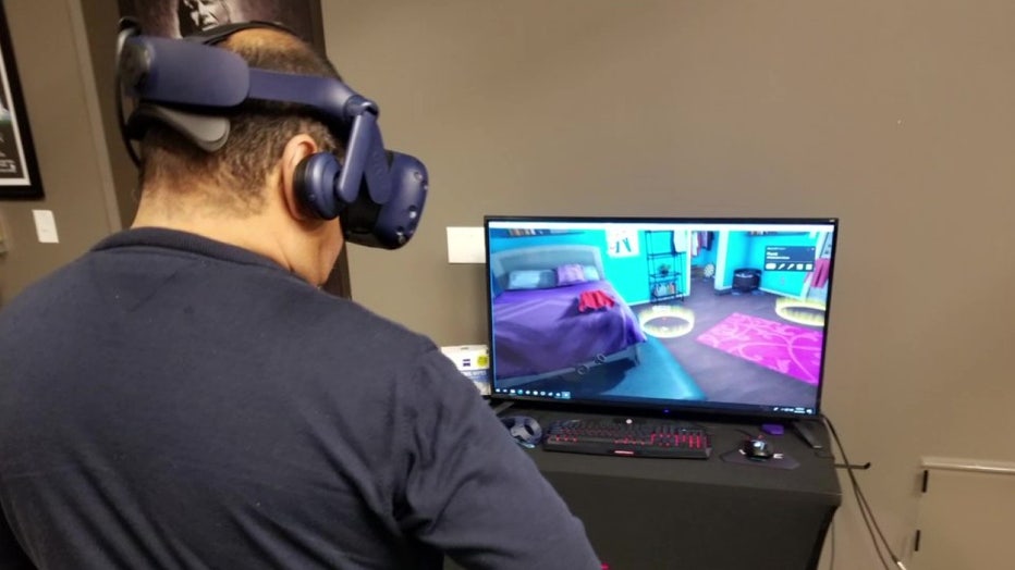 Man with headset uses virtual reality program. 