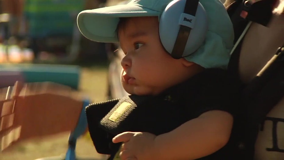 Baby wears headphones at Gasparilla Music Festival.