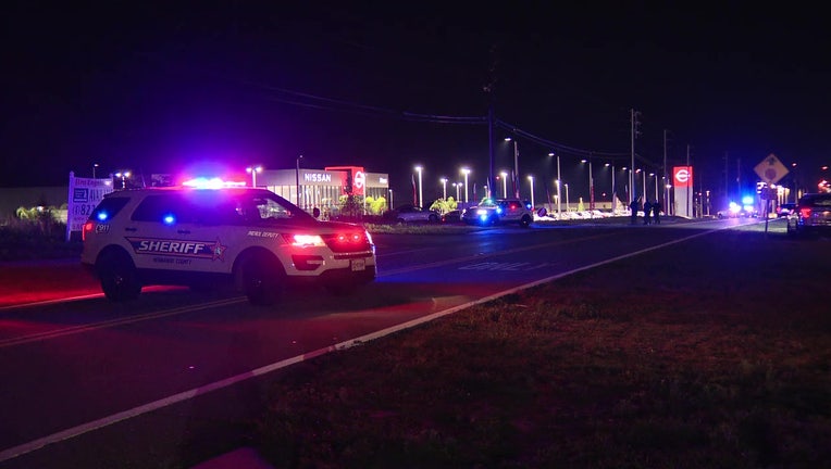 Law enforcement vehicles outside the scene of a fatal car crash. 