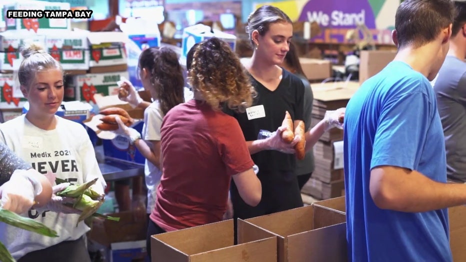 Volunteers load boxes at Feeding Tampa Bay. 
