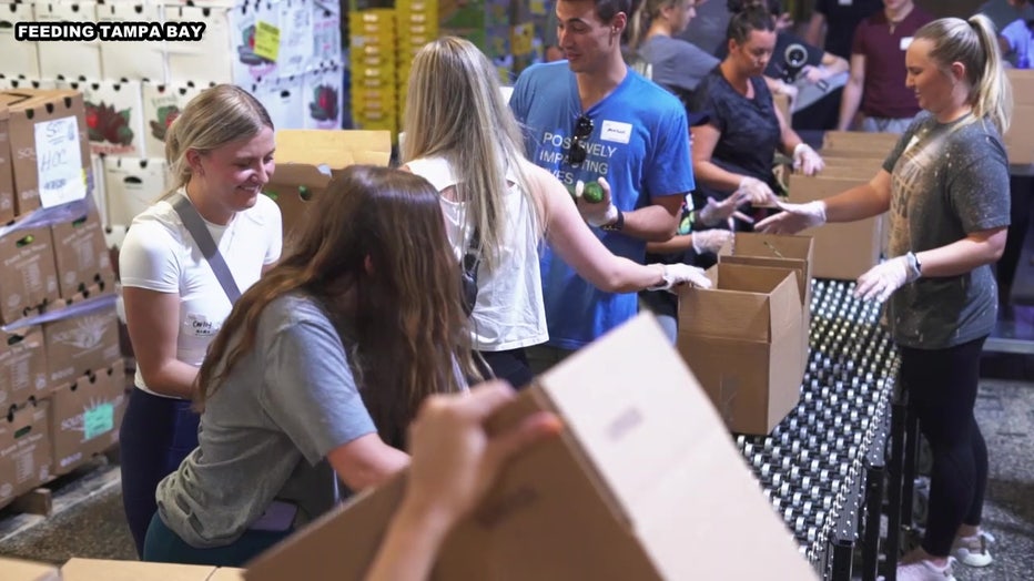 Volunteers load boxes at Feeding Tampa Bay. 