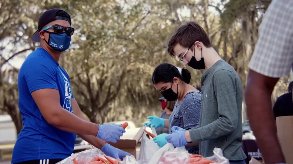 Volunteers sort food at Feeding Tampa Bay. 