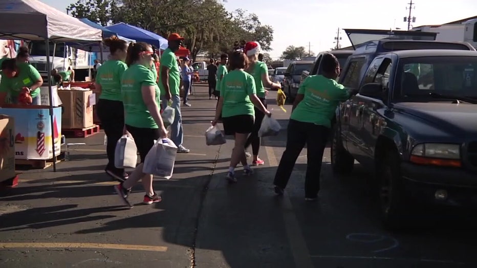 Volunteers load cars at Feeding Tampa Bay. 