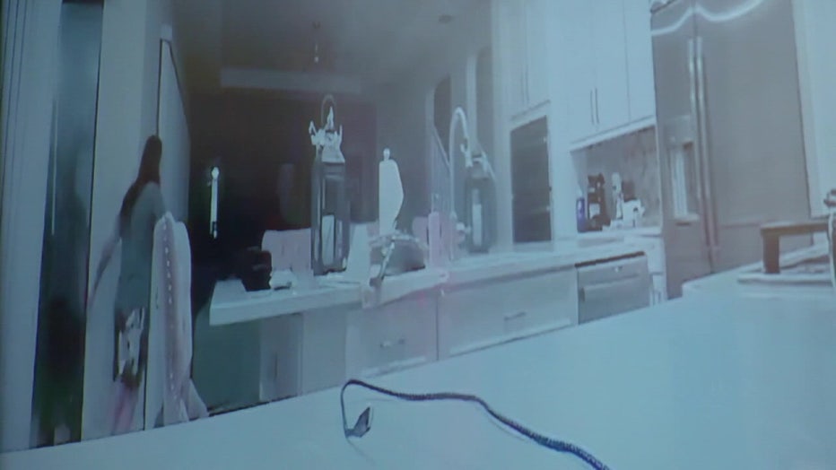 Surveillance video inside Deville's home shows her looking outside and then Thomas walking through her home. 