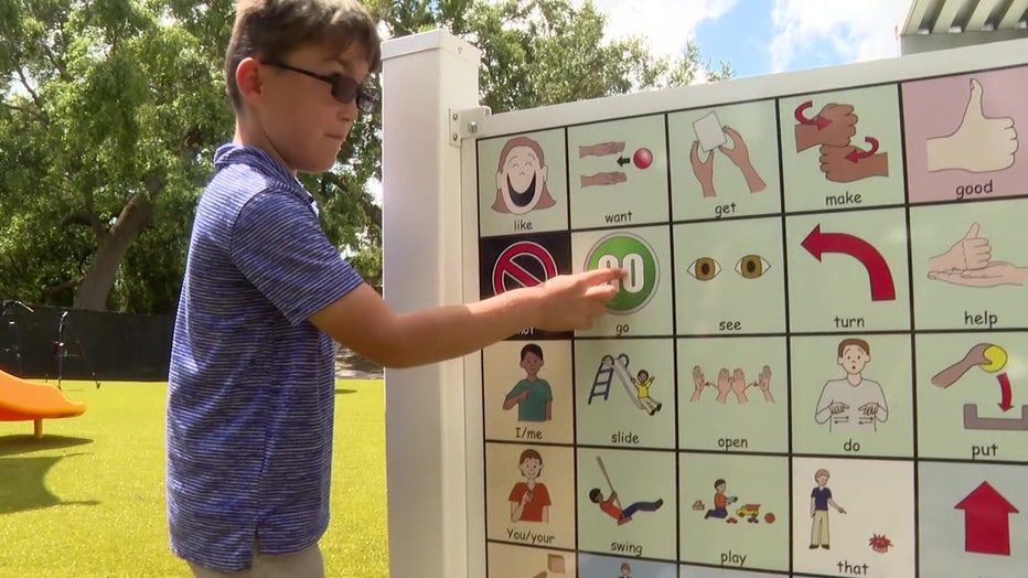 The playground has a board to help non-verbal students communicate. 