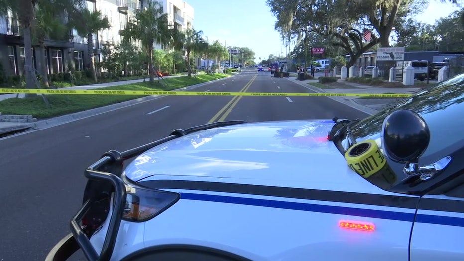 Law enforcement vehicle and crimes scene tape at scene of crash. 