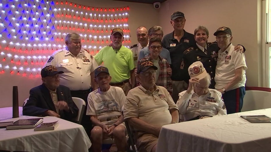 Isaac Shindore poses for a photo with WWII vets.