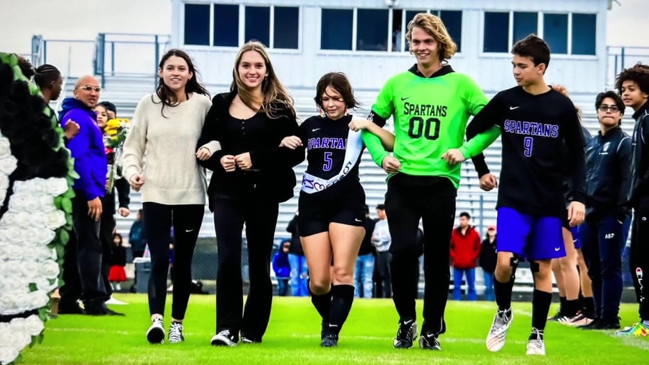 Abigail Beckton honored on field during sporting event. 