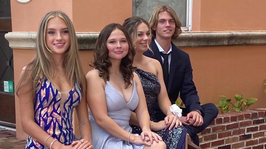 Abigail Beckton with friends at formal event.