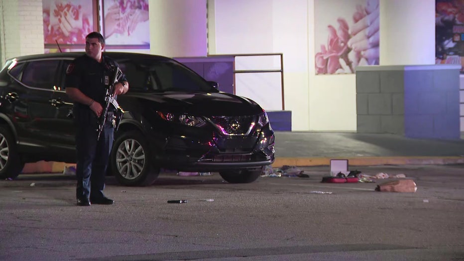 An armed law enforcement officer at the scene of an early morning shooting that injured one person. 