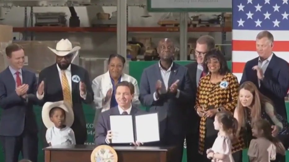 Ron DeSantis signing immigration bill. 