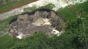 75-foot sinkhole forms on private property in Polk County, roads barricaded until further notice: Officials