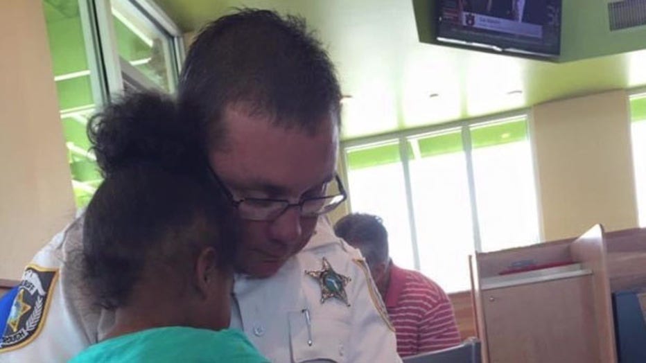 A picture captured in 2015 shows a young child giving him a hug on his lunch break. Courtesy: HCSO 