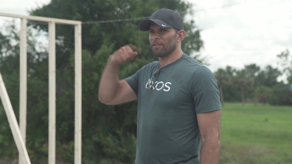 Former Buccaneer Ryan Nece supervises student volunteers helping with Hurricane Ian clean up.