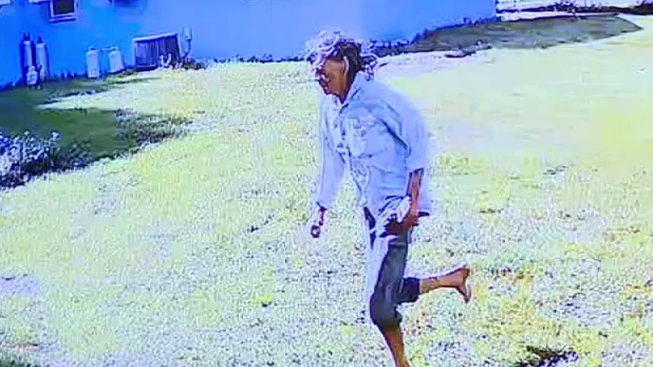 The jury was shown home surveillance video of a woman running through a yard after she says she saw the machete attack. 