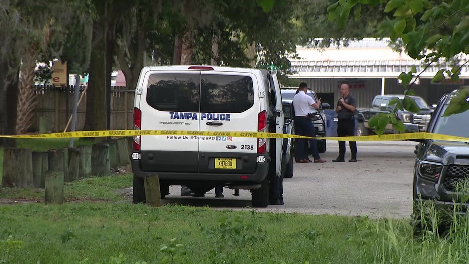 Crime scene tape and a forensic van outside a deadly shooting scene in Tampa. 