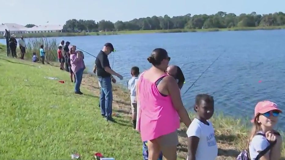 Children fish with Sheriff Grady Judd. 