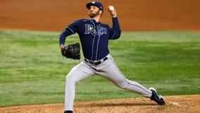 Chapman gets his first victory for Texas as the Tampa Bay Rays allow the winning run on a wild pitch in 9th