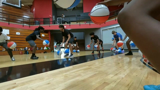 Kids learn from college basketball coaches and athletes at Brandon Giles Skills Camp