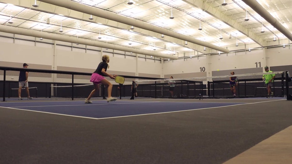 Sarasota couple plays pickleball with granddaughter. 