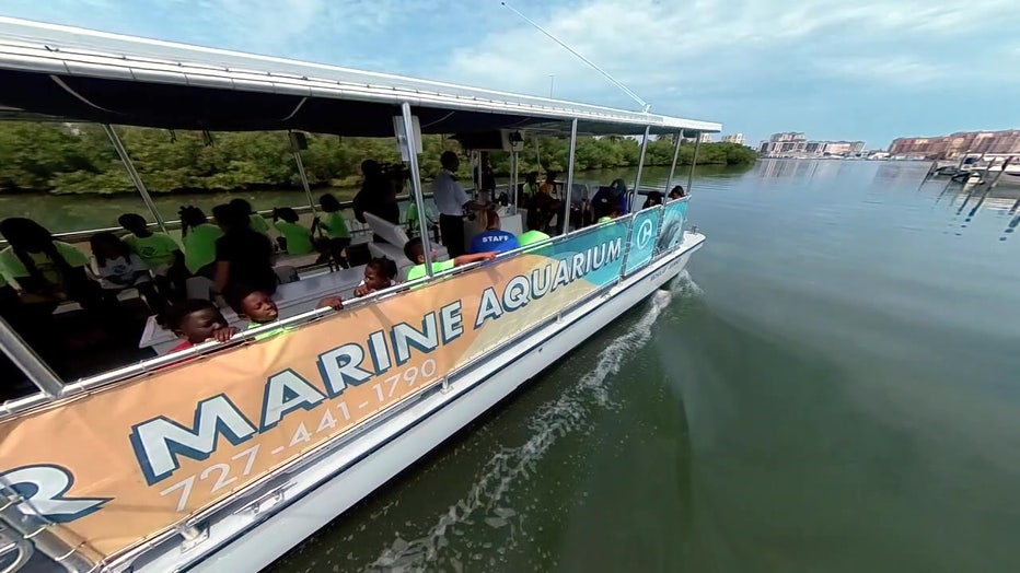 The kids set sail on a pontoon boat. 