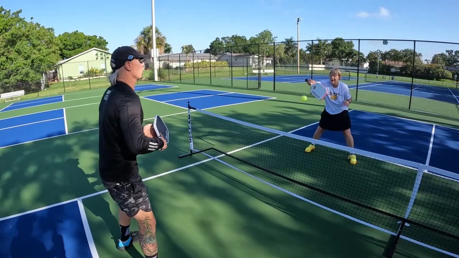 Peggy Ann West gets pickleball lesson from her coach. 